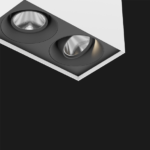 A black and white suspended box pendant light on a black background.