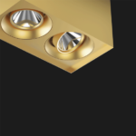 A gold suspended box pendant light on a black background.