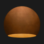 A corten sphere textured pendant light on a black background.