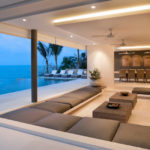 A luxury living room with ocean views sofas and led downlights