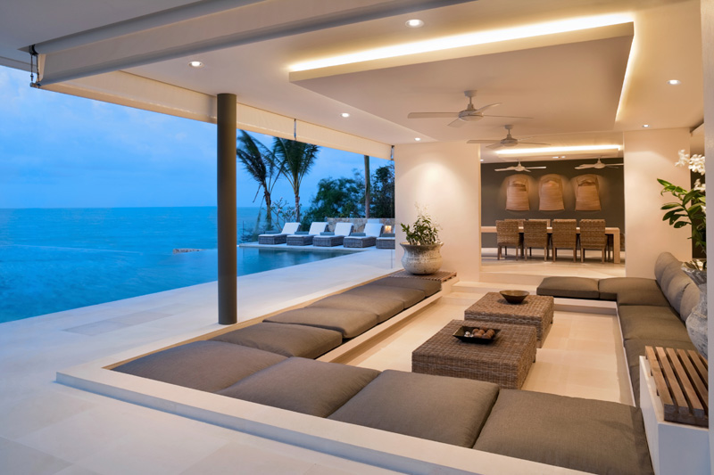 A luxury living room with ocean views sofas and led downlights