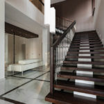 Luxury hall with staircase of a modern house with two large pendant lights.